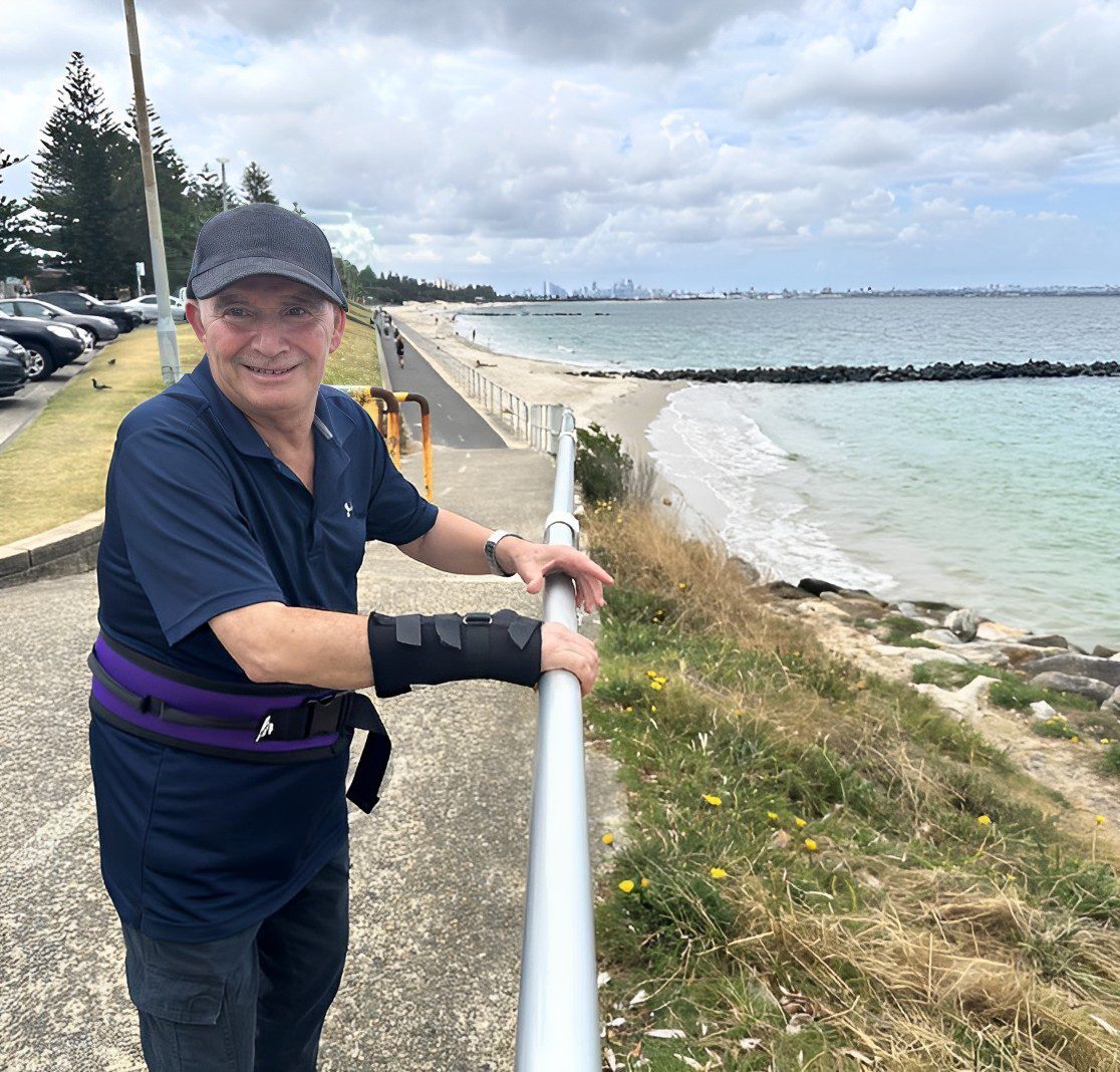 man with disability smiling next to the ocean